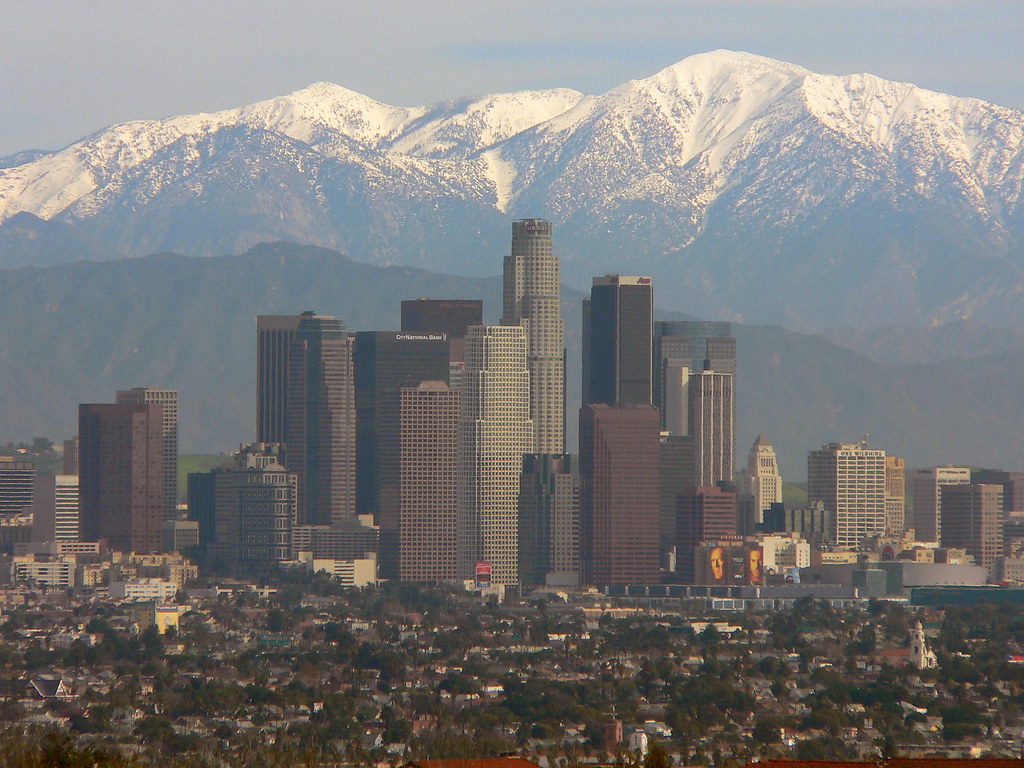 Downtown Los Angeles skyline with the snow-capped San Gabriel Mountains rising behind it