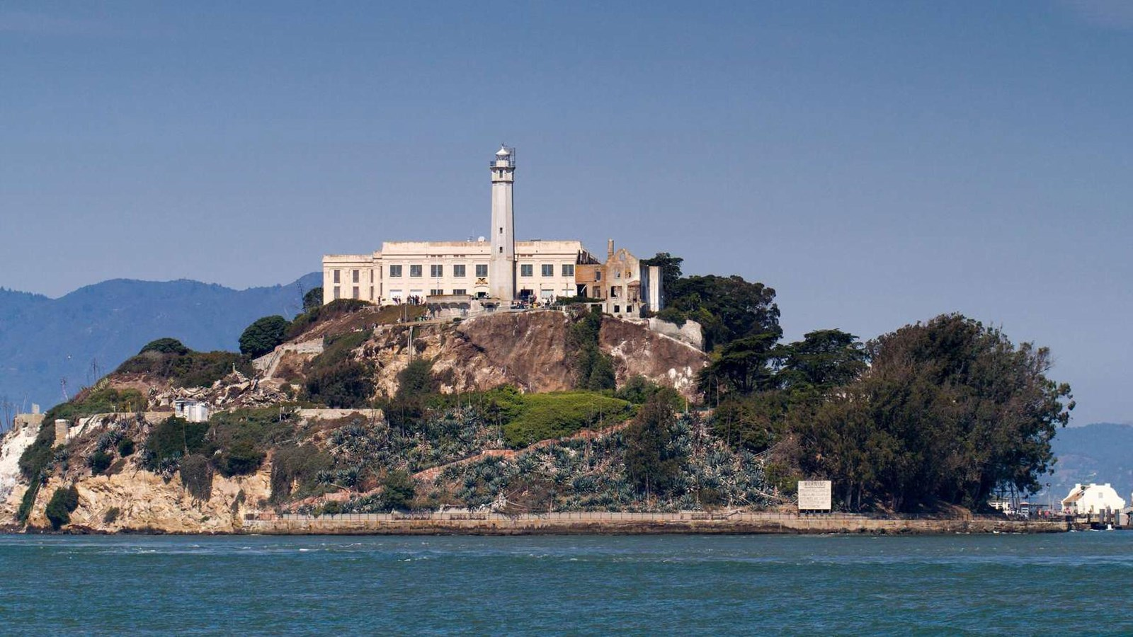 Alcatraz Island's cellhouse and lighthouse seen from San Francisco Bay